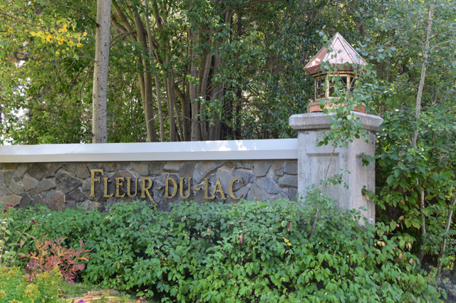 Modern-day perimeter wall with Fleur du Lac signage